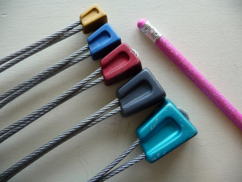 climbing nut - showing the size range of the dmm offsets with a pencil for size...