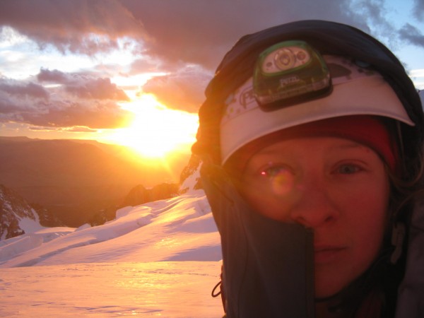 McKenzie Long wearing the Petzl Elia Helmet at dawn on a glacier appro...