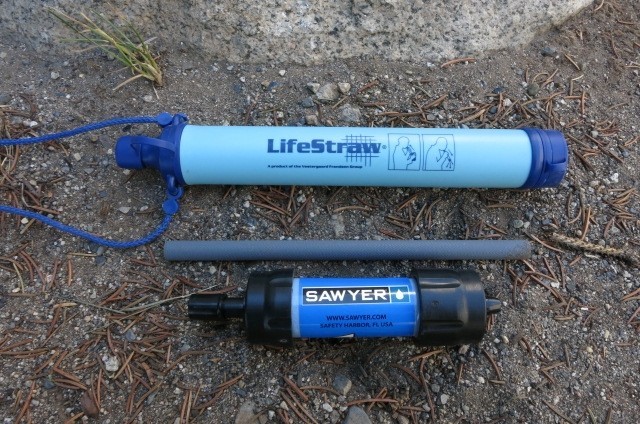 the sawyer mini (and its included straw) next to the lifestraw (top)...