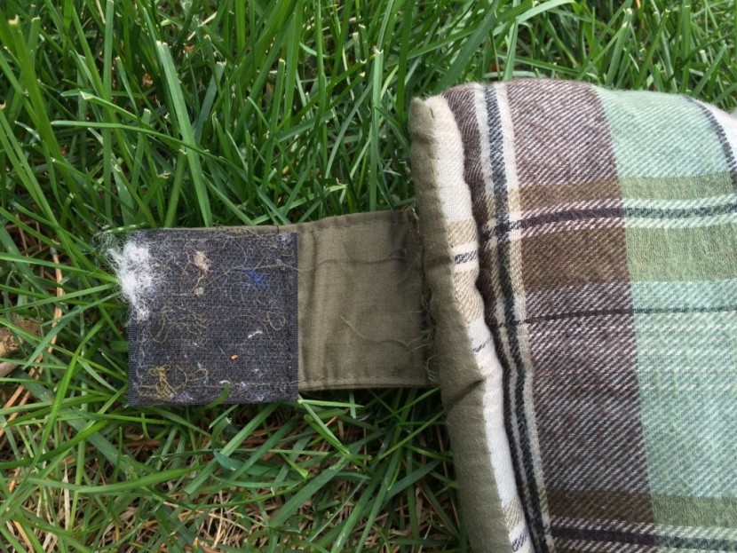 wenzel conquest - the zipper closure strap doesn't fold away onto itself on this...