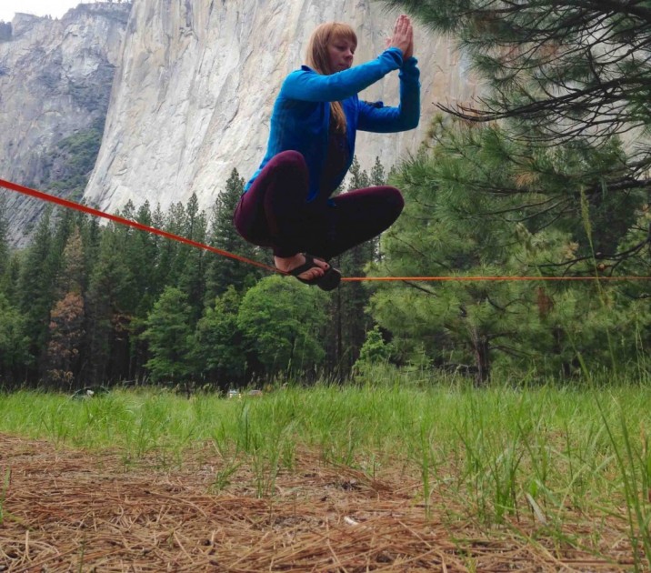 slackline - libby sauter works on her &quot;buddha&quot; pose while practicing static...