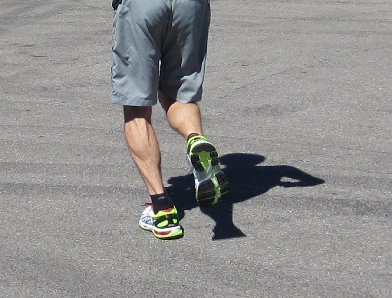 asics gel-kayano 21 - clearly seen on the outsole of the runner&#039;s right foot, the yellow...