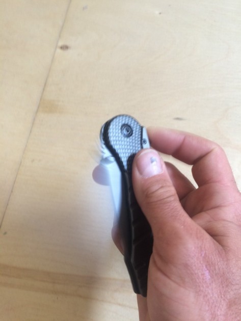 neokut black kryptonite - action shot of the neokut's assisted opening blade. the visible...