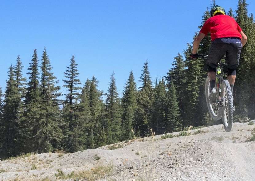 continental trail king 2.2 protection - our lead tester paul tindal rolling through a jump line at mammoth.