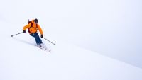 A skier in the flat light of Zermatt's flat-light, glaciated skiing...
