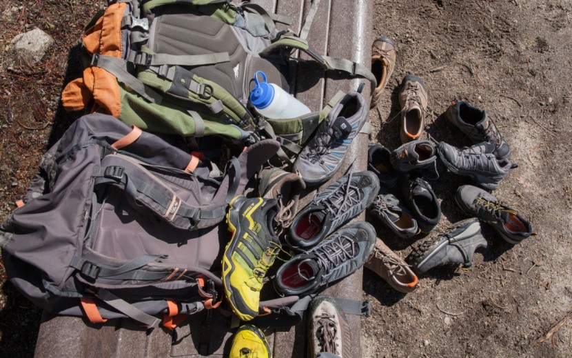 hiking shoes men - one water bottle, two backpacks, and ten pairs of shoes. prepping...