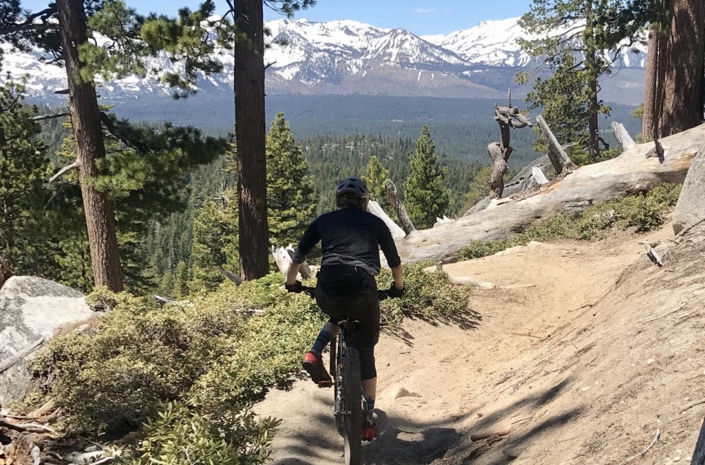 mountain bike pedals - a tester unclipping to drop a foot and rally through the steep...