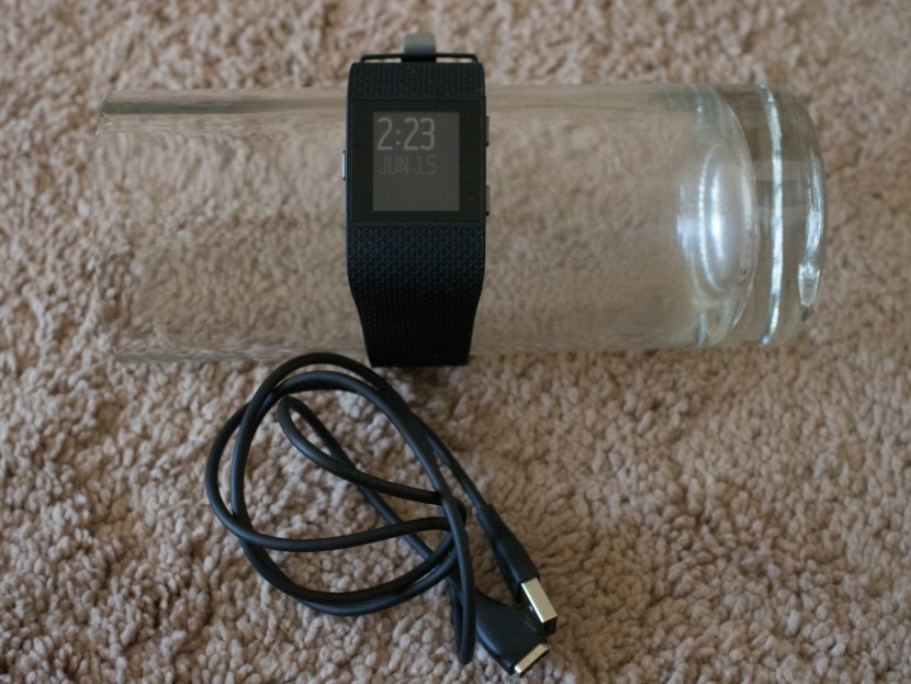 fitbit surge - the surge and charging cable.