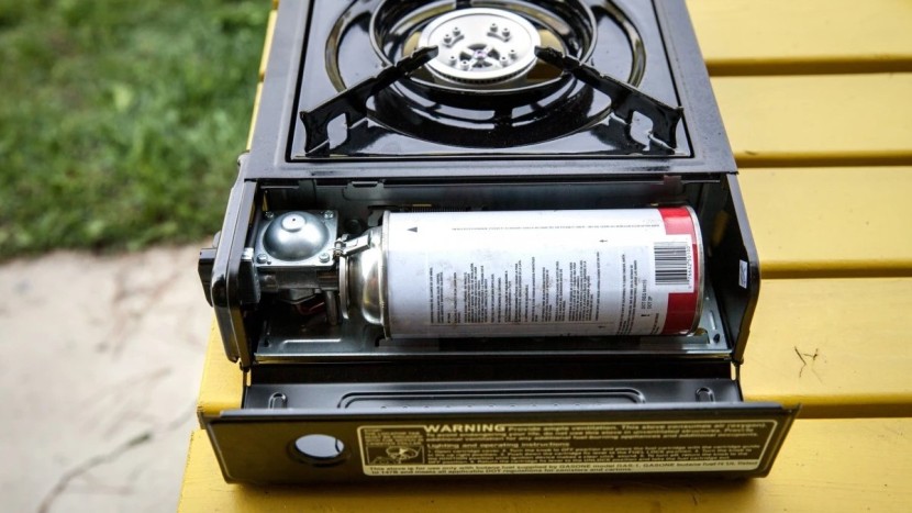 camping stove - a butane canister tucks into the side compartment for quick, easy...