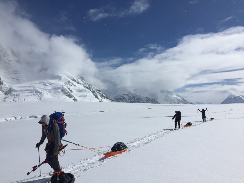 mountaineering backpack - dragging sleds on an expedition in alaska.