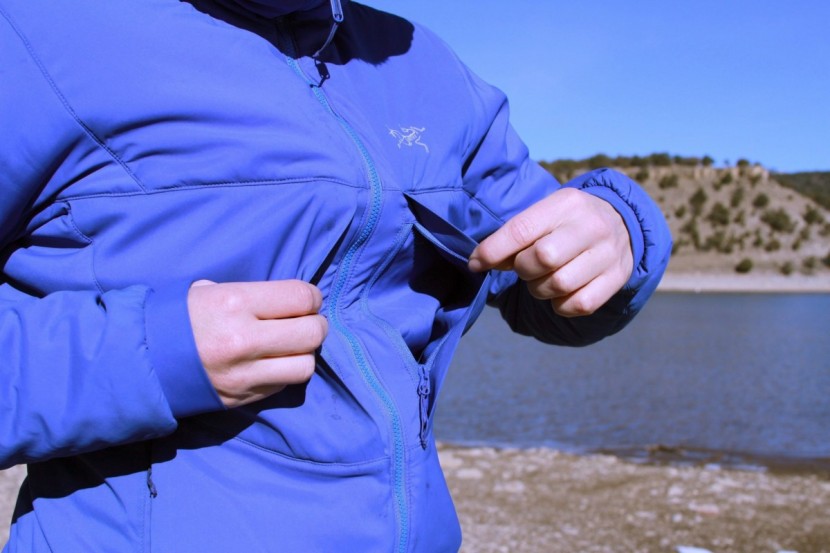 this jacket features two exterior breast pockets and two hand warmer...