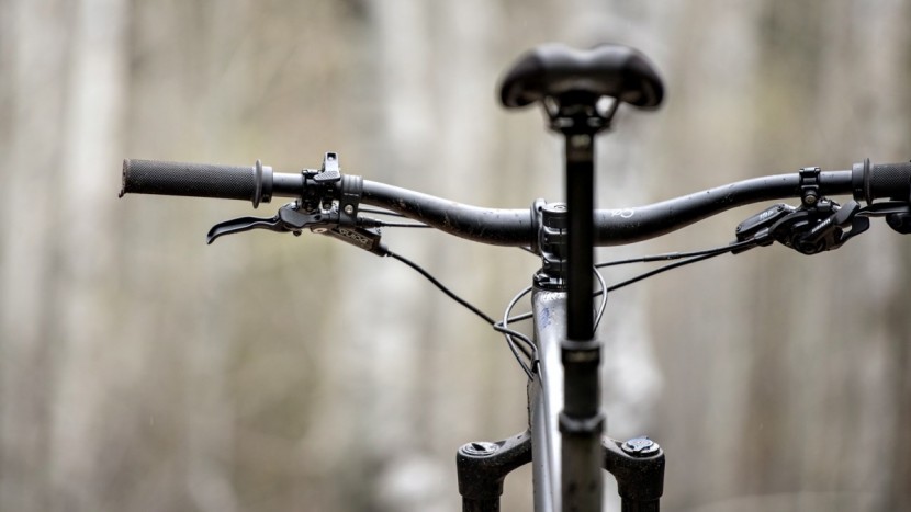 the crowded left side of the handlebar features a dropper lever and...