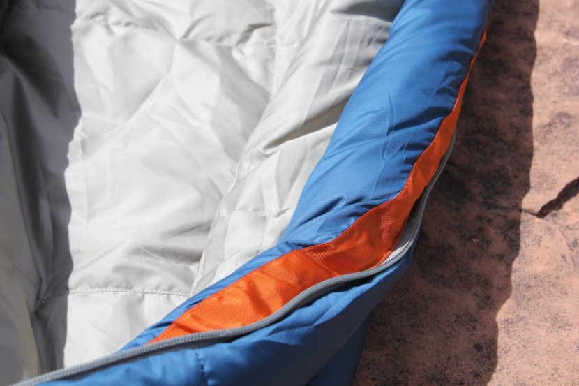 camping sleeping bag - zipper baffles keep the drafts at bay.