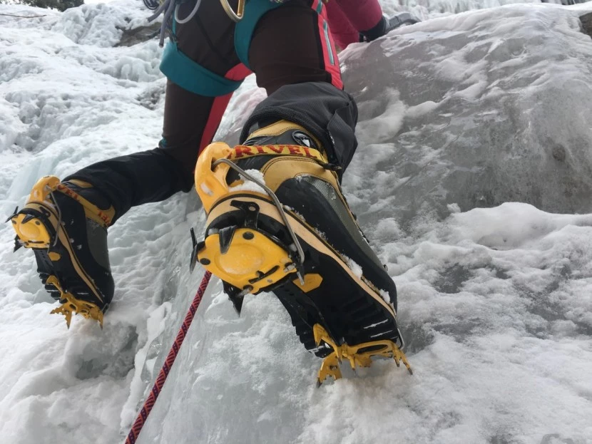 Close-up of women's mountaineering boots being maintained with leather treatment