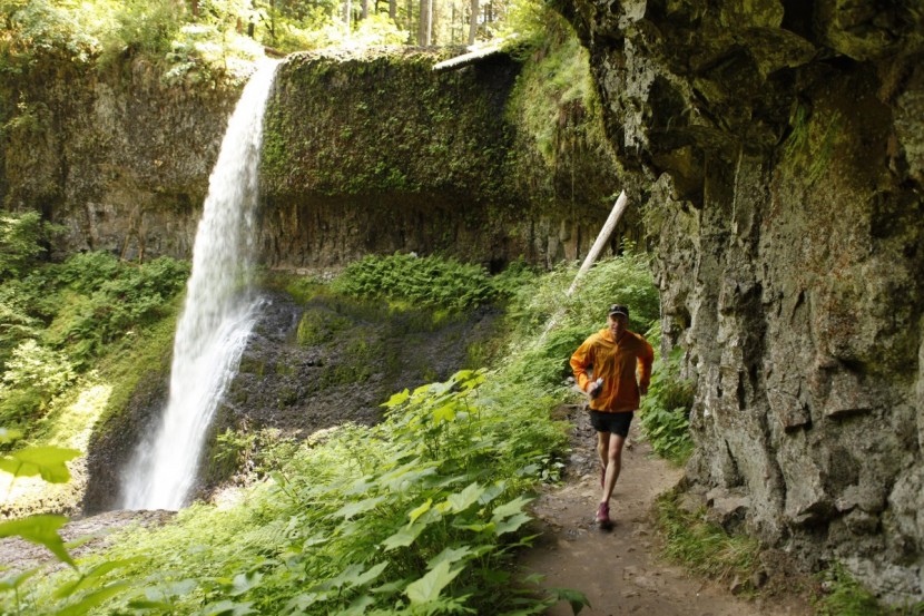 trail running shoes men - running in front of one of the 10 amazing waterfalls along the 10...