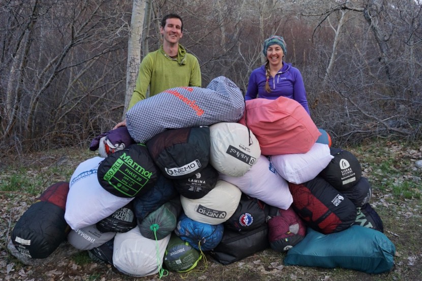 the authors of the our backpacking sleeping bag reviews with a pile...