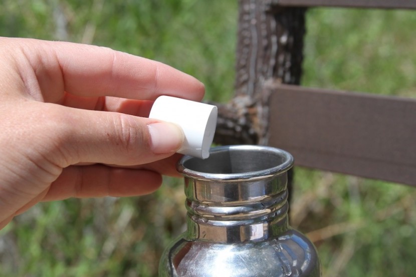 backpacking water filter - pouring the aquamira drops into our water to kill anything that we&#039;d...