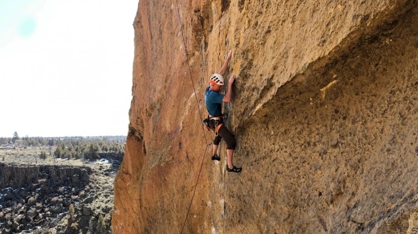 climbing helmet - climbing a route on the welded tuff of smith rock while wearing the...