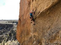 Climbing a route on the welded tuff of Smith Rock while wearing the...