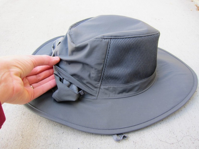 outdoor research ghost rain - tucking the rain flap away into the back of the hat. this is an...