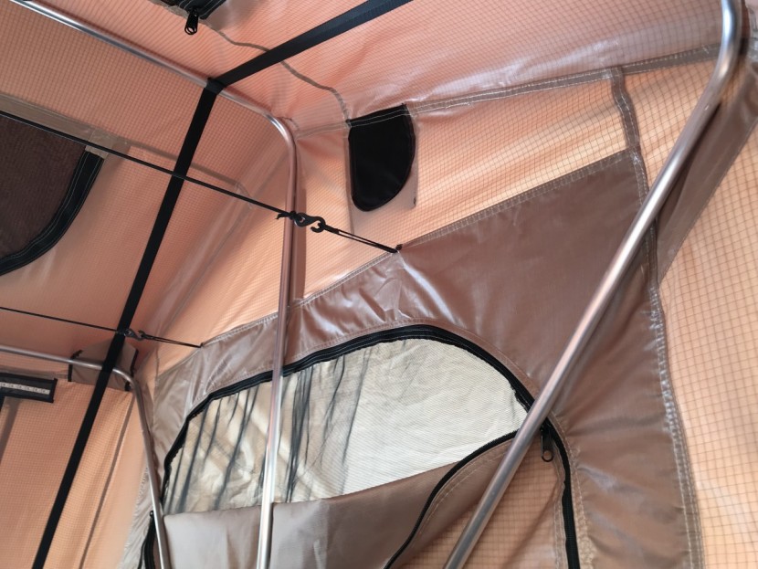 rooftop tent - small details like bungee cords to help the canopy fold up while...