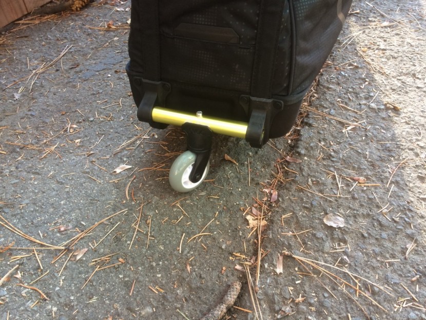 evoc travel bag pro - a clip-on front-wheel secures to a bar and swivels for clean steering.