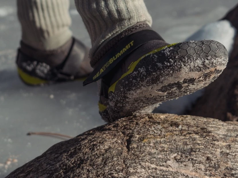 Testing Sea to Summit Ultra Flex Booties on icy, slippery shoreline with rocks