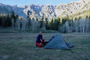 Claire starts by staking out the corners of the tent, before...