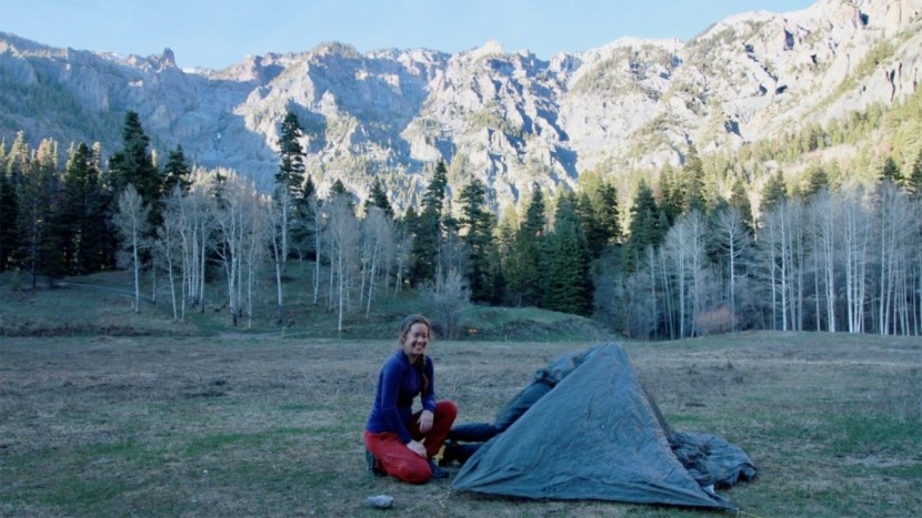 claire starts by staking out the corners of the tent, before...