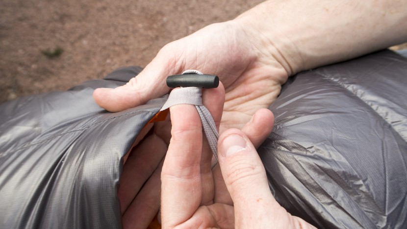 the rei trail magma 30 quilt uses long toggle buttons on its straps...
