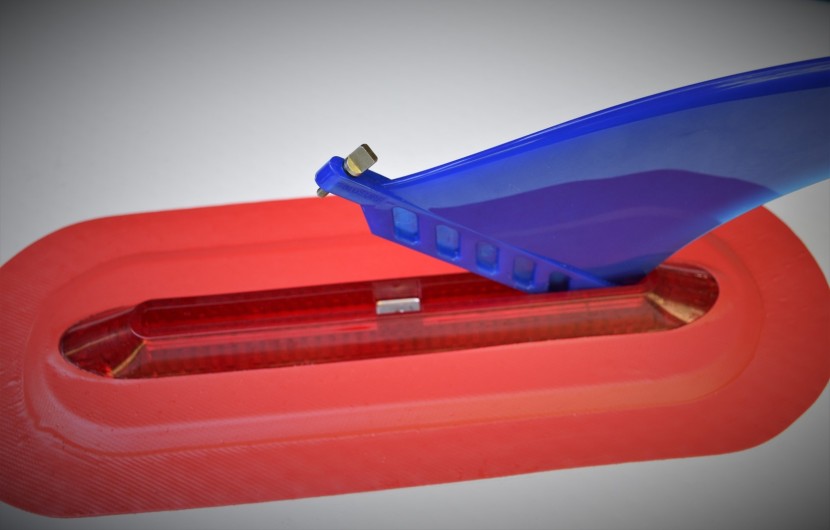 the larger center fin connects to the fin box with a traditional...