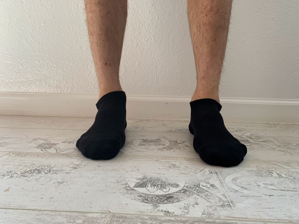 A boy wearing no-show socks that only covers his toes and heels on