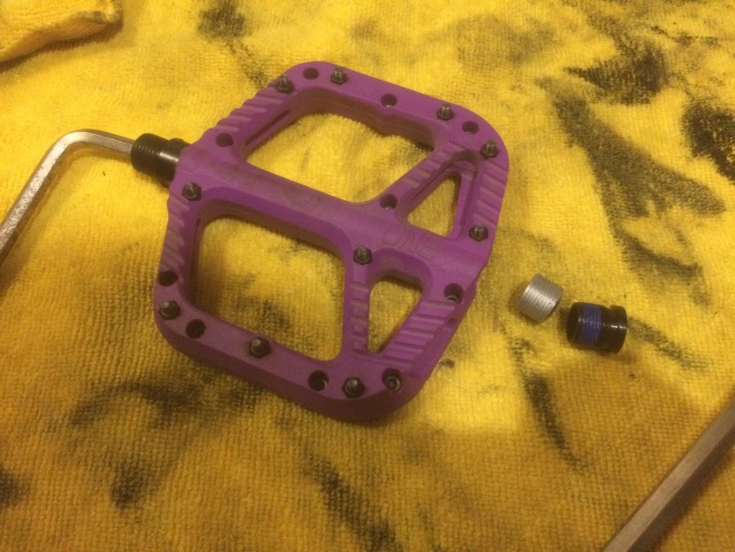 oneup components composite - removing the outer retaining bolt (black) and inner bolt (silver)...