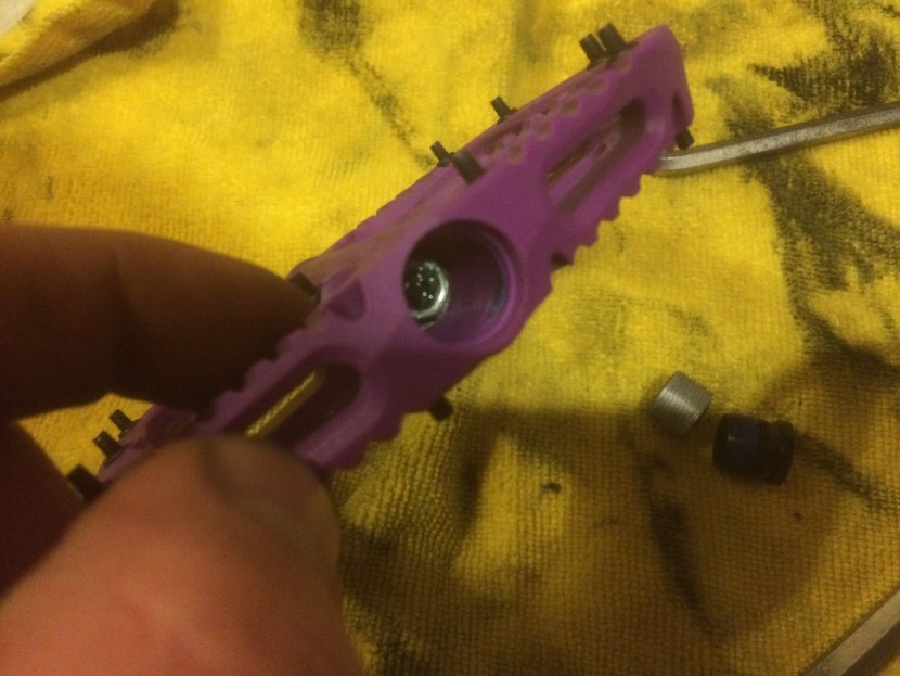 oneup components composite - use a socket to remove the retaining nut and the axle pulls out.