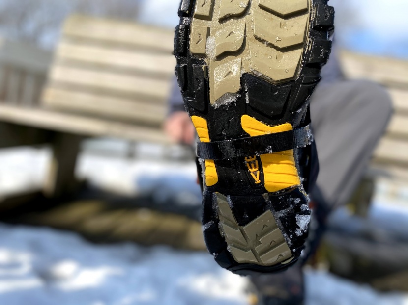 the adjustable instep strap is a coated plastic.