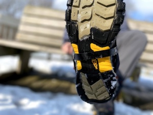 The adjustable instep strap is a coated plastic.