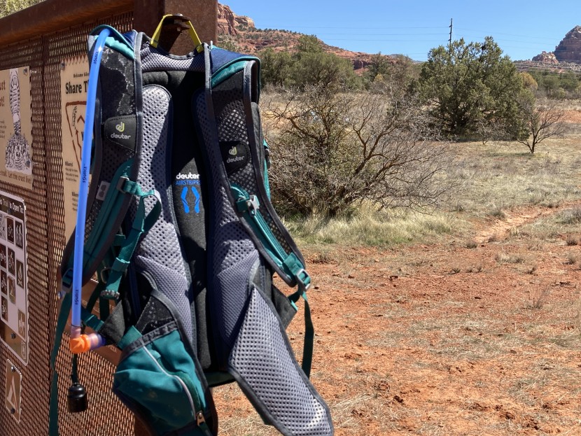 deuter compact exp 12 - the hydration hose routes through the velcro tabs labeled deuter...