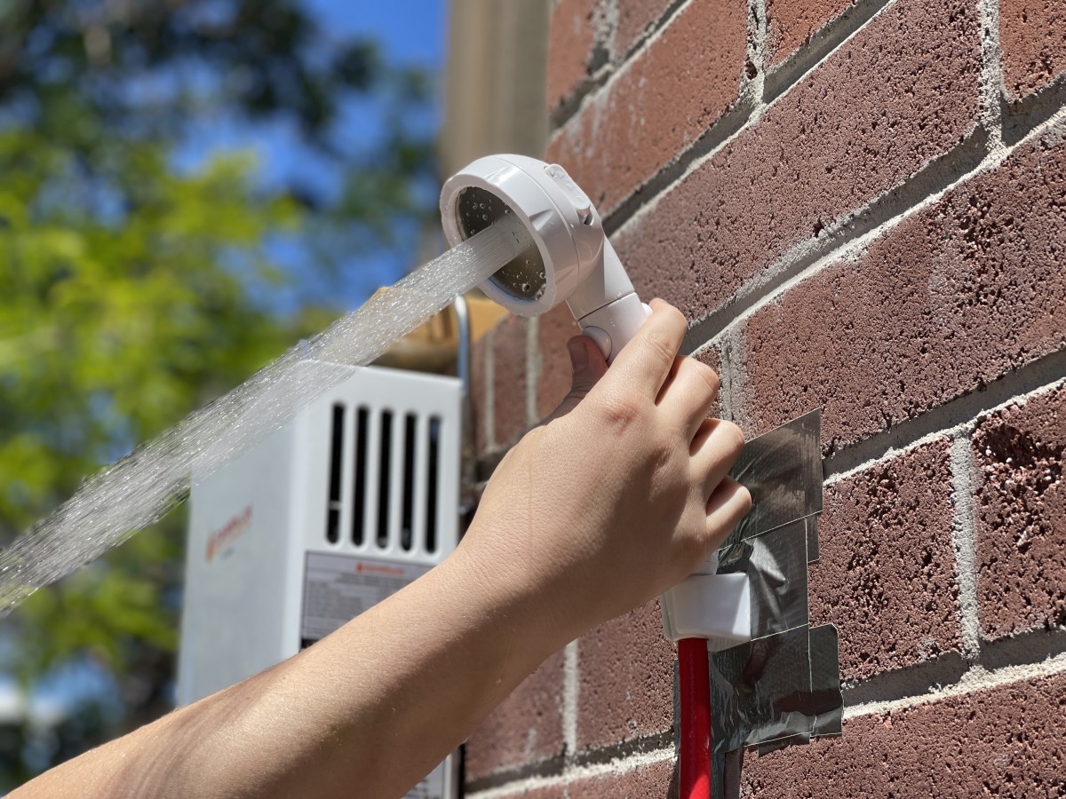 Camplux Pro Series 6L Review (An included shower head mount helps keep your hands free - though we had to duct tape ours to this brick wall.)