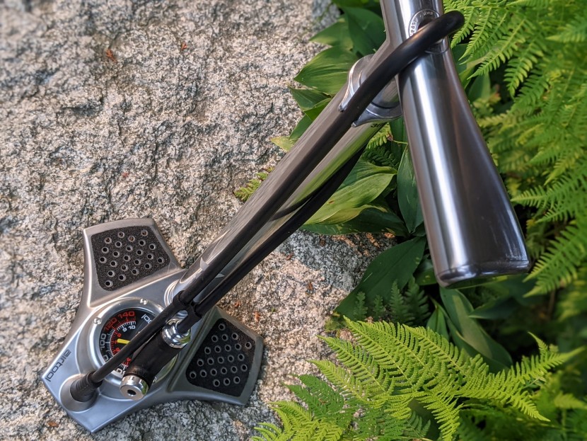 a slideable clasp holds the nozzle securely against the hose itself.