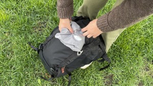 Pulling the included rain cover out of the dedicated stow pocket.