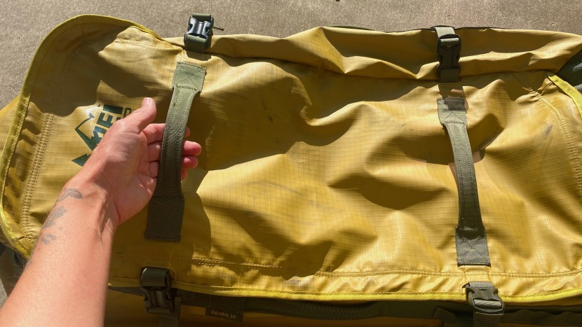extra load handles on the front of rei's big haul rolling duffel...