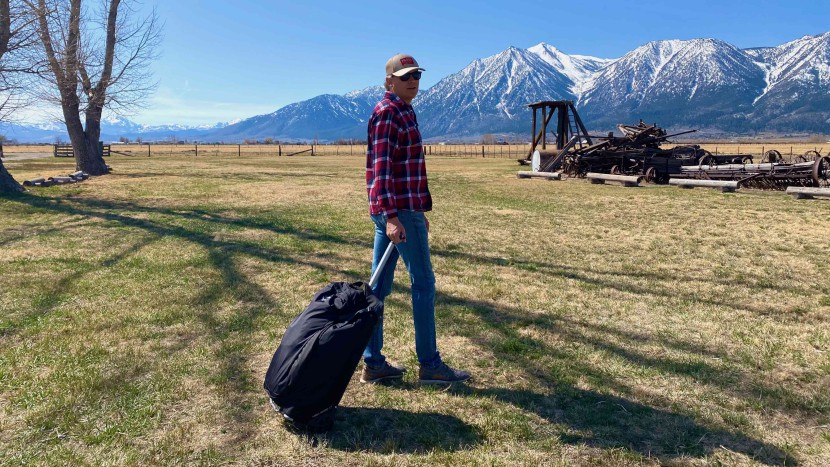 osprey ozone 75l wheeled - covering grassy terrain with the osprey ozone wheeled 75l.