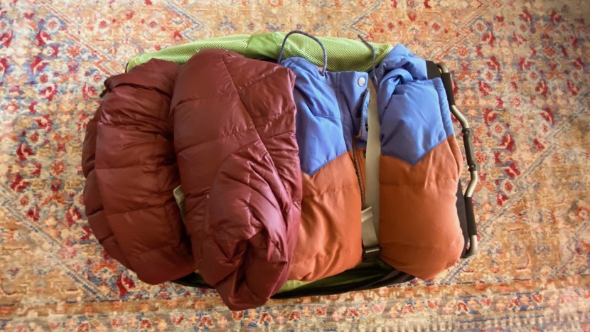 an overflowing osprey ozone wheeled 75l ready to zip up.