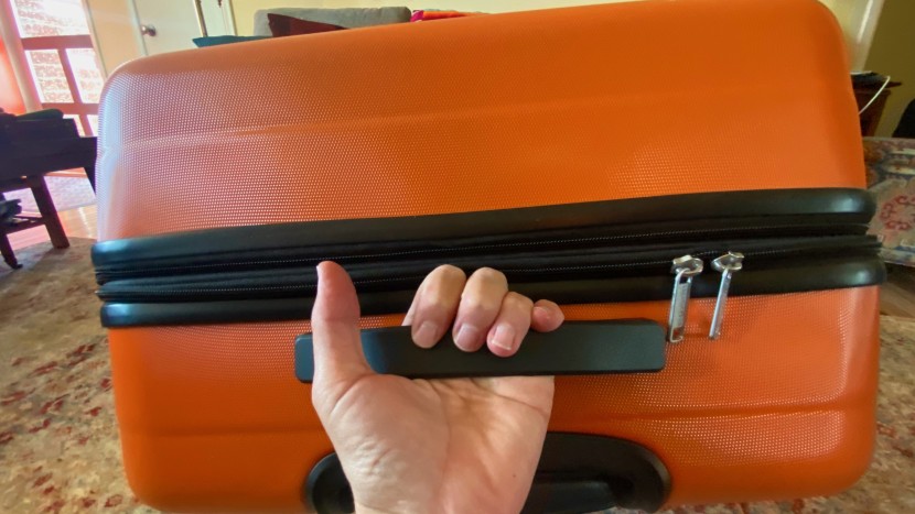 amazon basics 30&quot; hardside spinner - load handle in use on the amazon basics expandable spinner bag.