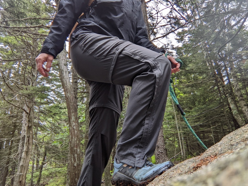 Woman wearing water resistant hiking pants on mountain trail
