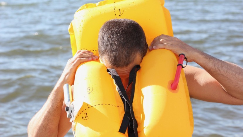 nrs zephyr - use the two black straps to help widen the opening of the pfd and...