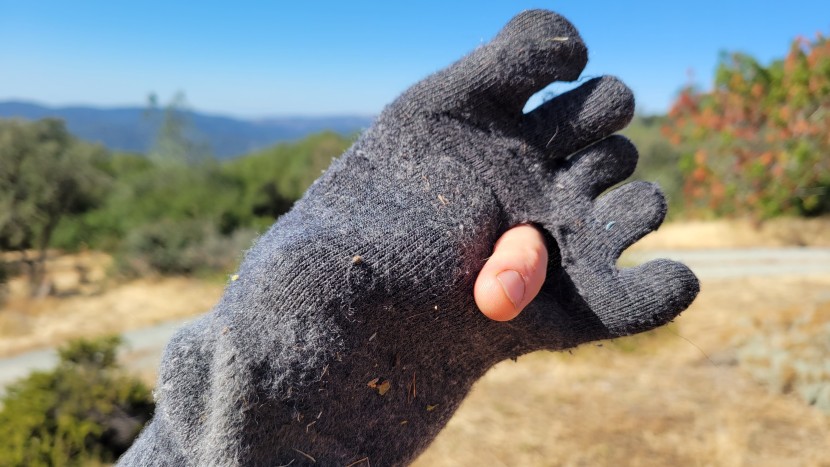 we test hard. here is the injinji outdoor midweight crew with a hole...