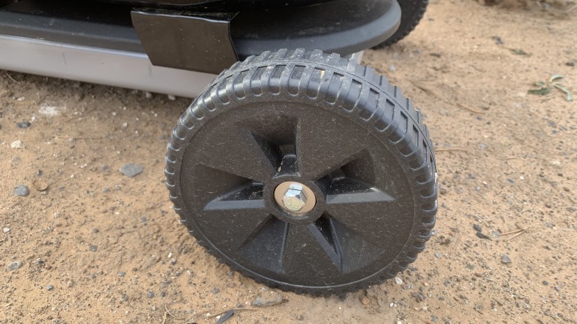 large plastic wheels help while transporting the coleman roadtrip 285.