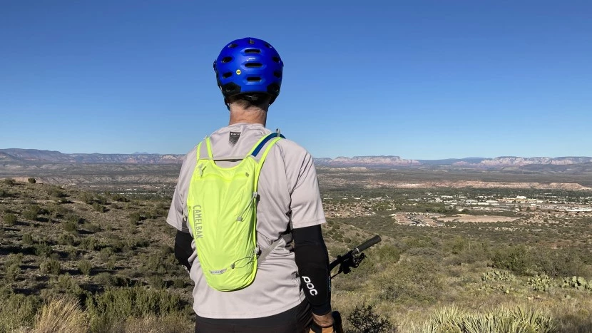 Experienced hiker demonstrating proper water bag setup and maintenance techniques on trail