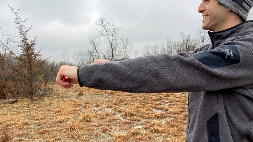 checking out the mobility of the arc'teryx covert cardigan.